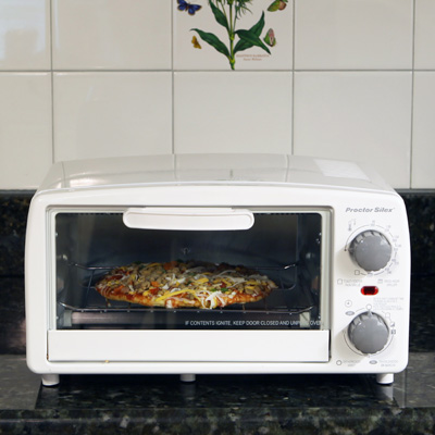 PROCTOR SILEX® 4-Slice Toaster Oven - This 4-slice toaster oven includes a built-in 15 minute timer with automatic shutoff and ready bell,  baking pan and broiler function along with a removable crumb tray to make cleanup a snap.